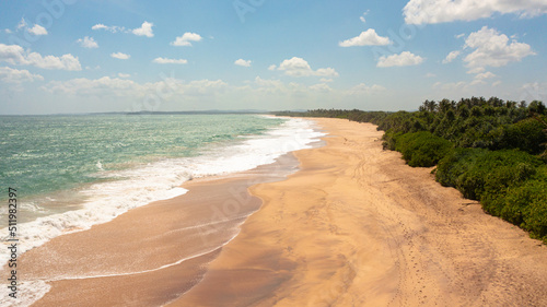 Seascape with tropical sandy beach and blue ocean. Sri Lanka.
