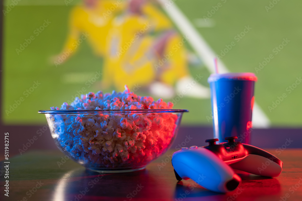 Sports Popcorn Video games. Popcorn, drink and joystick on the background of a large ...