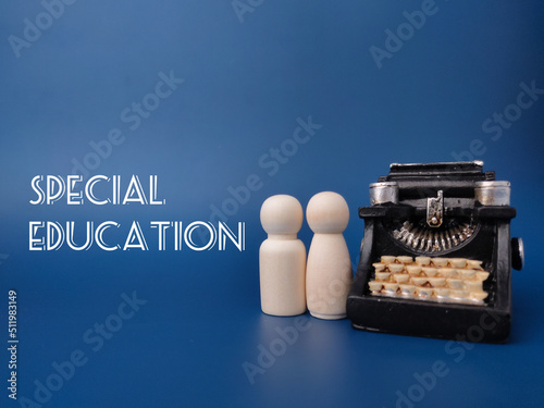 Wooden figures and vintage typewritter with the word SPECIAL EDUCATION. photo