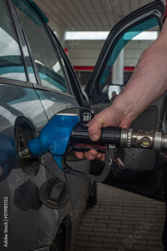 Refueling a car with fuel at a gas station