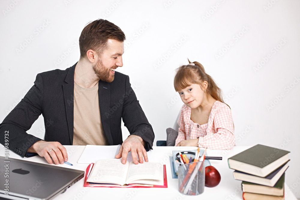 Girl with Down syndrome studying with her teacher at home Girl with Down syndrome studying with her teacher at home