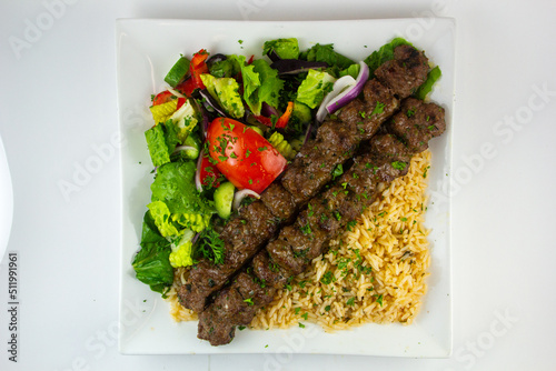 Kofta, a meatball dish found in Middle Eastern, South Caucasian, South Asian, Balkan, and Central Asian cuisines. Served with fries and salad.  photo