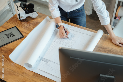 Selective focus, Asian female architect or engineer Drawing the design of the building structure in the blueprint. Asian female architect or engineer Sit and analyze, design projects in the office. photo