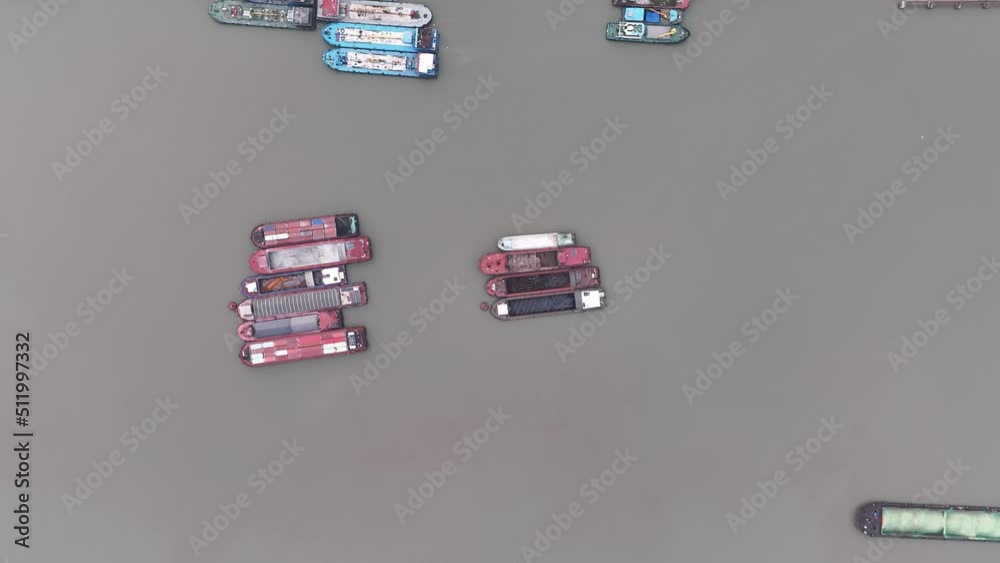 Drone aerial view of Small cargo boat in the river. Top view above. Red cargo boat stop in the gray polluted river in Shanghai China. Business, travel and life style concept b-roll footage. Drone aerial view of Small cargo boat in the river. Top view above. Red cargo boat stop in the gray polluted river in Shanghai China. Business, travel and life style concept b-roll footage.