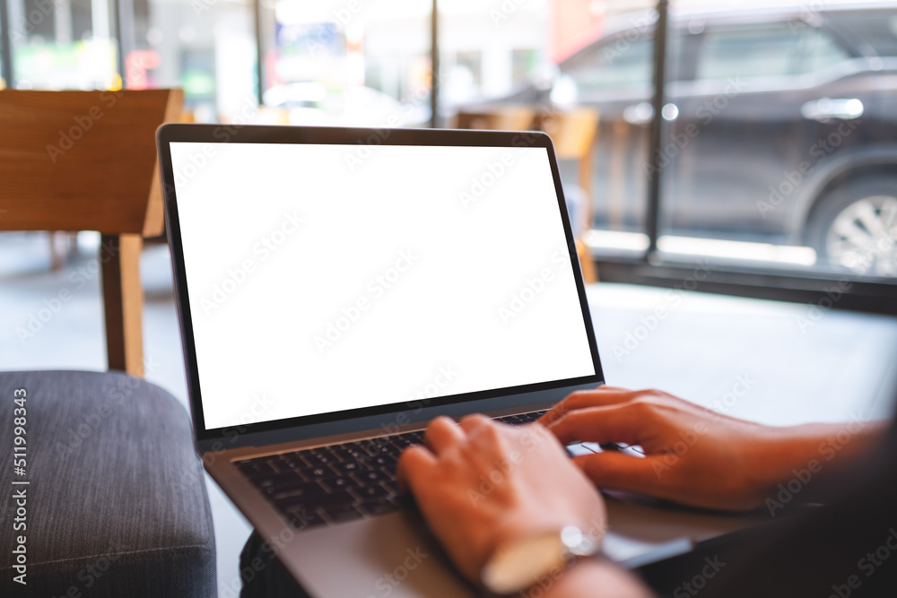 Mockup image of a woman working and typing on laptop with blank white desktop screen Mockup image of a woman working and typing on laptop with blank white desktop screen