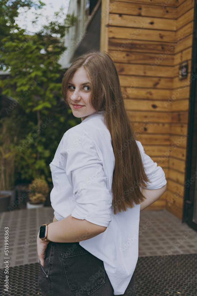 Fototapeta premium A girl in a white shirt in the city