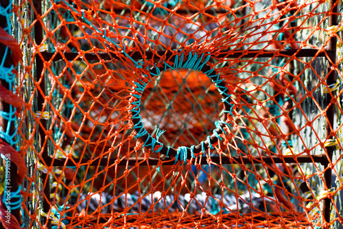 Colorful fishing lobster and crab baskets with blue and orange nets