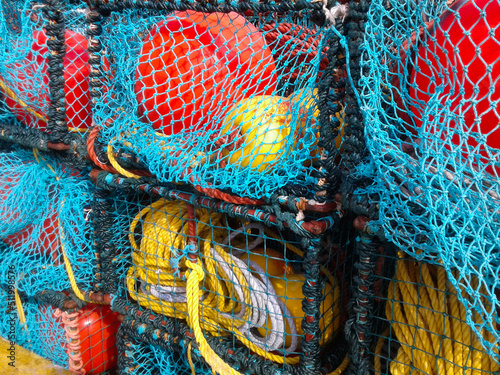 Colorful fishing lobster and crab baskets with blue and orange nets