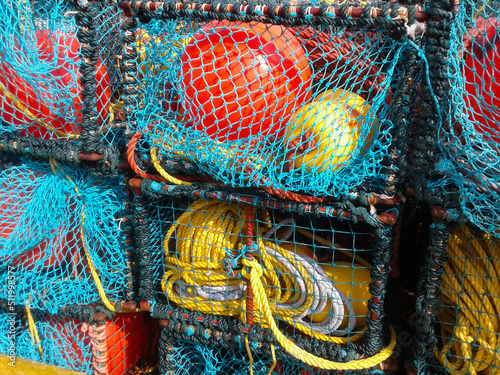 Colorful fishing lobster and crab baskets with blue and orange nets