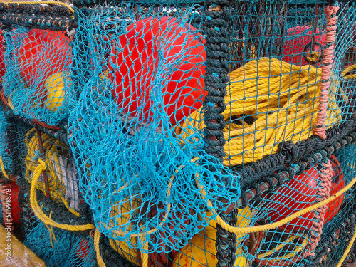 Colorful fishing lobster and crab baskets with blue and orange nets