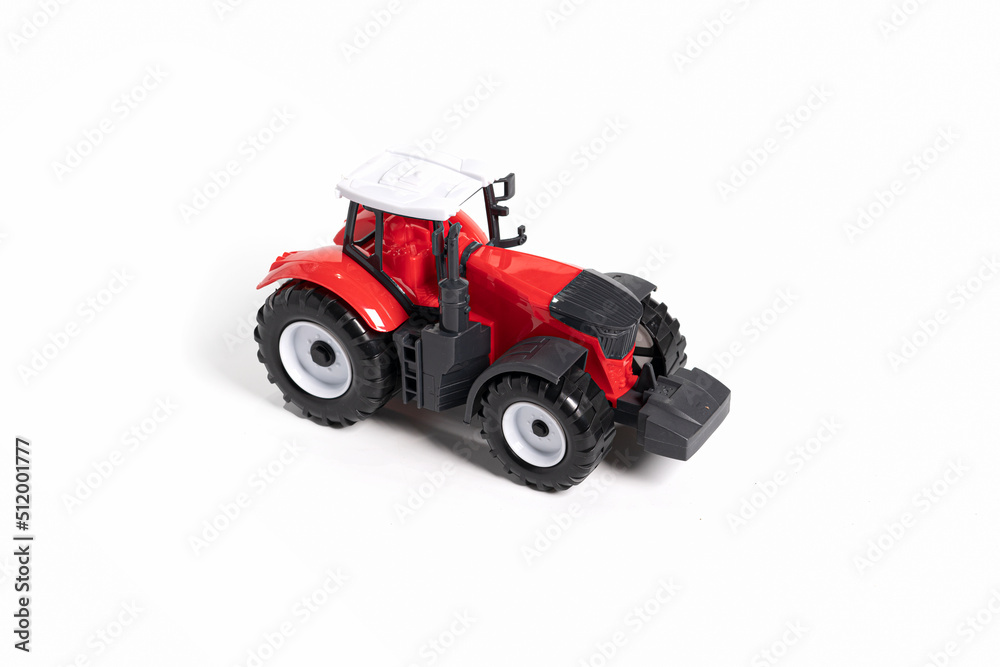 Red toy tractor isolated on white background. Red toy tractor isolated on white background.