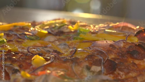 Freshly Cooked Pizza Steaming On The Table At Sunset. - close up, slider photo