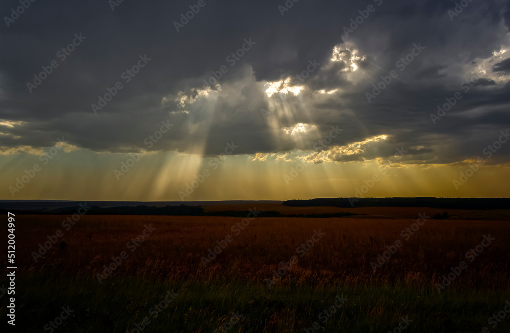 The rays of the sun break through the thunderclouds.