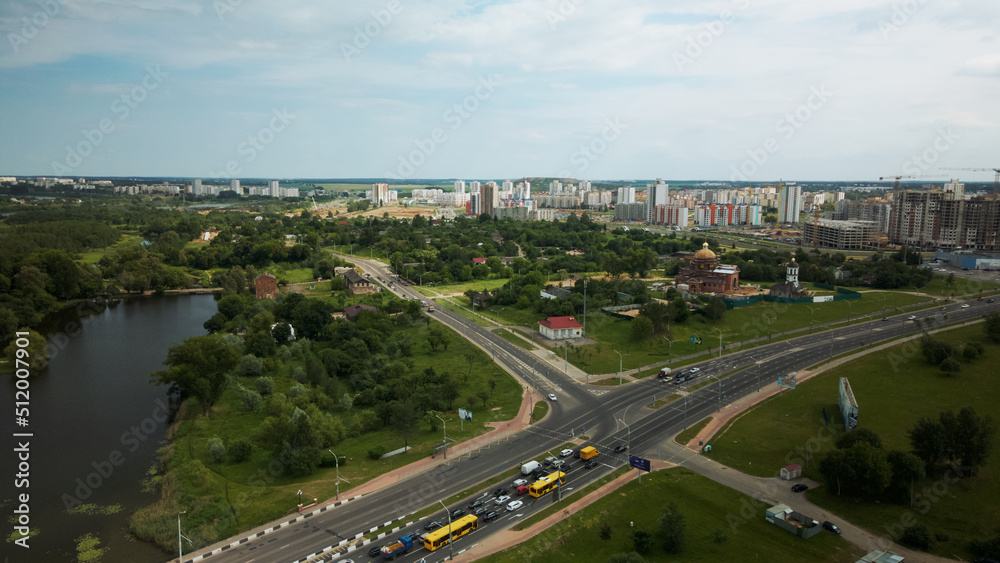 Crossroads of a large city highway. The flow of cars starts moving at a traffic light. Aerial photography.