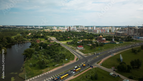 Crossroads of a large city highway. The flow of cars starts moving at a traffic light. Aerial photography.