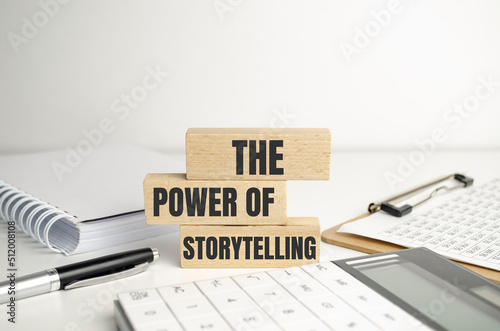 the power of storytelling - text on wooden blocks on dark grey background.