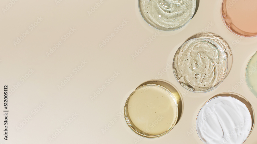 Various cosmetic products in Petri dishes on beige background view from above. Copy space Various cosmetic products in Petri dishes on beige background view from above. Copy space