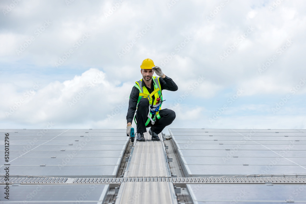 Engineer working setup Solar panel at the roof top. Engineer or worker work on solar panels or solar cells on the roof of business building Engineer working setup Solar panel at the roof top. Engineer or worker work on solar panels or solar cells on the roof of business building