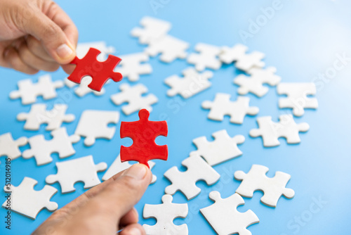 Human hands holding red jigsaw  with word problem & solution.  symbol of association and connection. business strategy.
