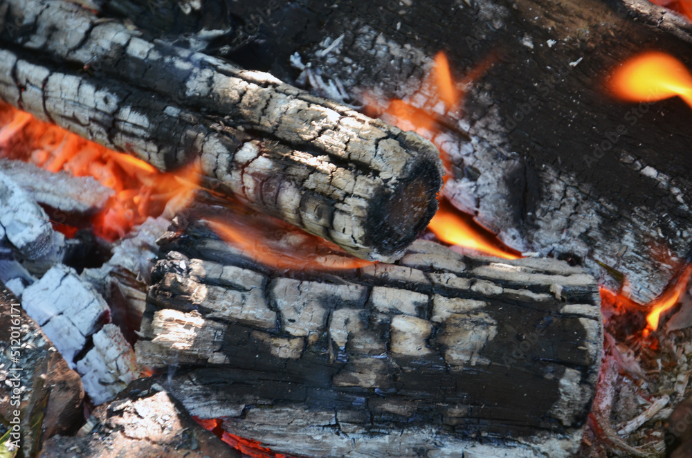 Burning firewood close up. Firewood burning on the grill. bonfire close up Burning firewood close up. Firewood burning on the grill. bonfire close up