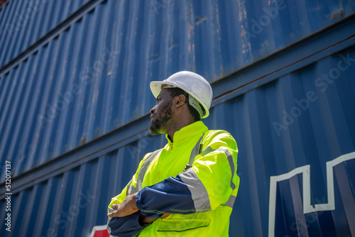 African American working engineer foreman radio control in port cargo shipping container yard.