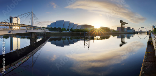 Glasgow Cityscape at sunrise, skyline panorama with reflecion in river with sun, Scotland - UK