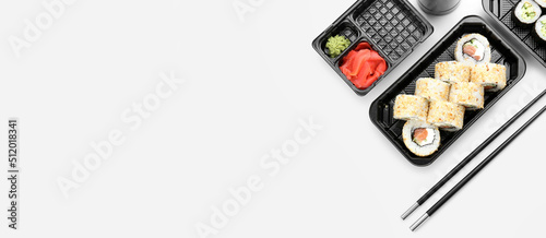 Composition with tasty sushi rolls on white background with space for text