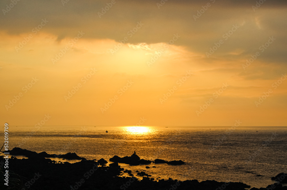 Sunset on the beach seen from the shore