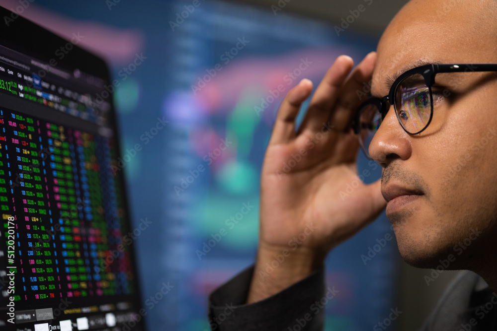 Investor businessman analyzing a graphic of a stock cryptocurrency exchange chart and looks at computer monitor. Financial analyst working with real-time exchange rate diagram. Investment concept Investor businessman analyzing a graphic of a stock cryptocurrency exchange chart and looks at computer monitor. Financial analyst working with real-time exchange rate diagram. Investment concept
