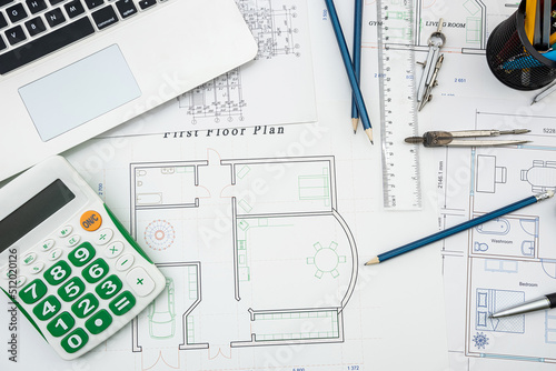 Top view drawing of the architects of a modern house with a sample material on table.