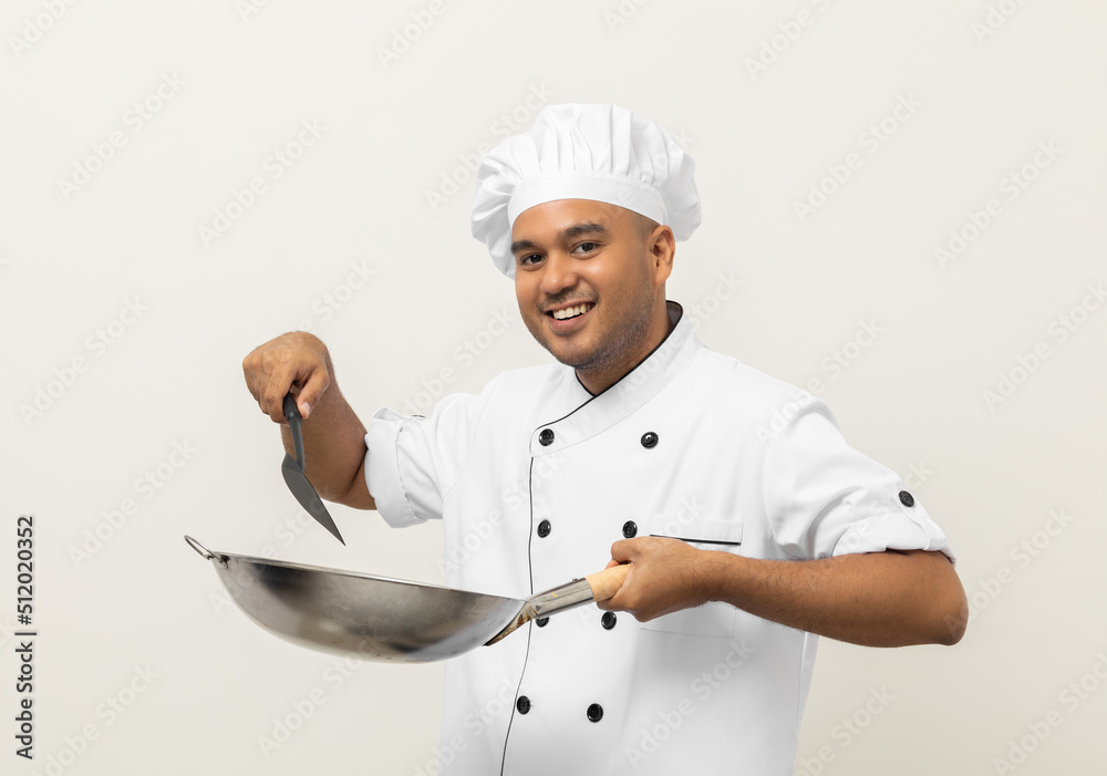 Young handsome asian man chef in uniform holding turner and iron Frying pan utensils cooking in the kitchen various gesture on isolated background. Indian man Occupation chef restaurant and hotel. Young handsome asian man chef in uniform holding turner and iron Frying pan utensils cooking in the kitchen various gesture on isolated background. Indian man Occupation chef restaurant and hotel.