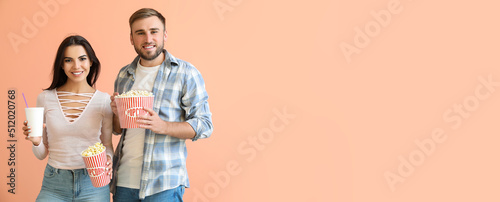 Young couple with popcorn a...