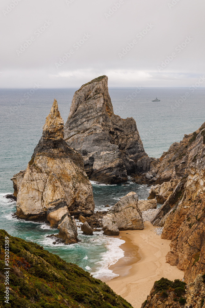 Naklejka premium Tall, rugged haystack rocks jut out of the Atlantic ocean along the Portugal coast