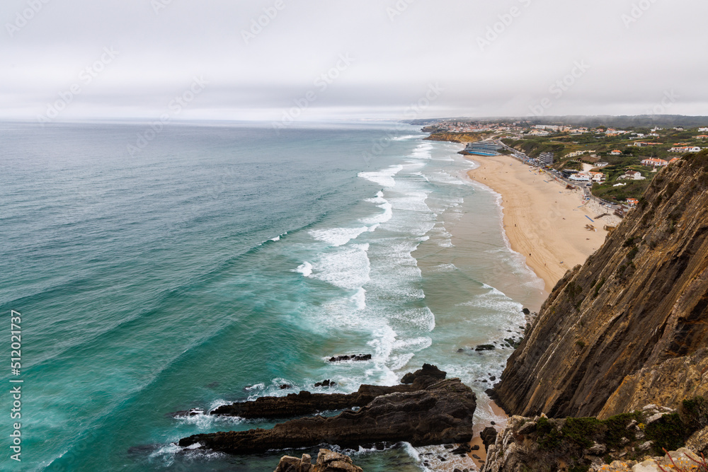 Obraz premium Rocky formations and fog amongst the waves on the coast of Portugal