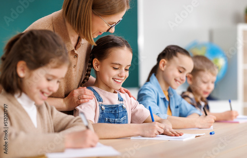 Teacher supporting kids during test