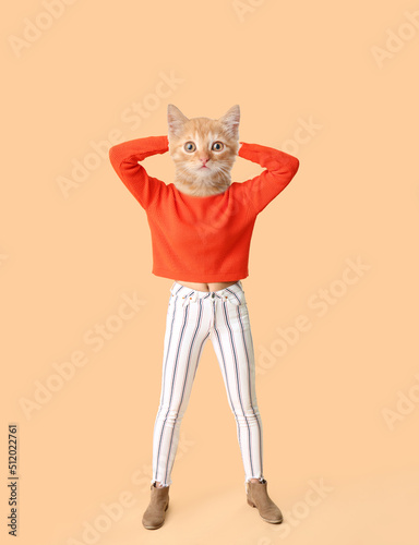 Funny kitten with human body on beige background photo