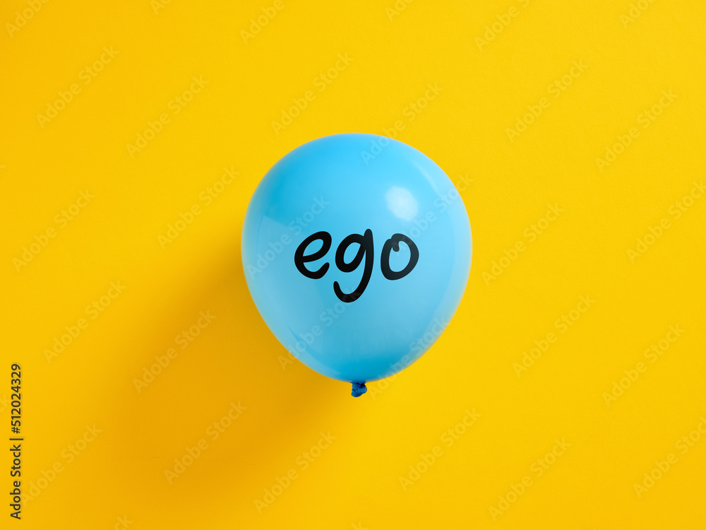 Inflated blue balloon with the word ego and a pin. Selfishness or