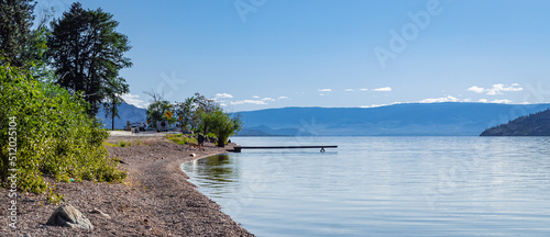 Wooden dock on a calm lake on beautiful summer morning, Okanagan Lake, Canada.