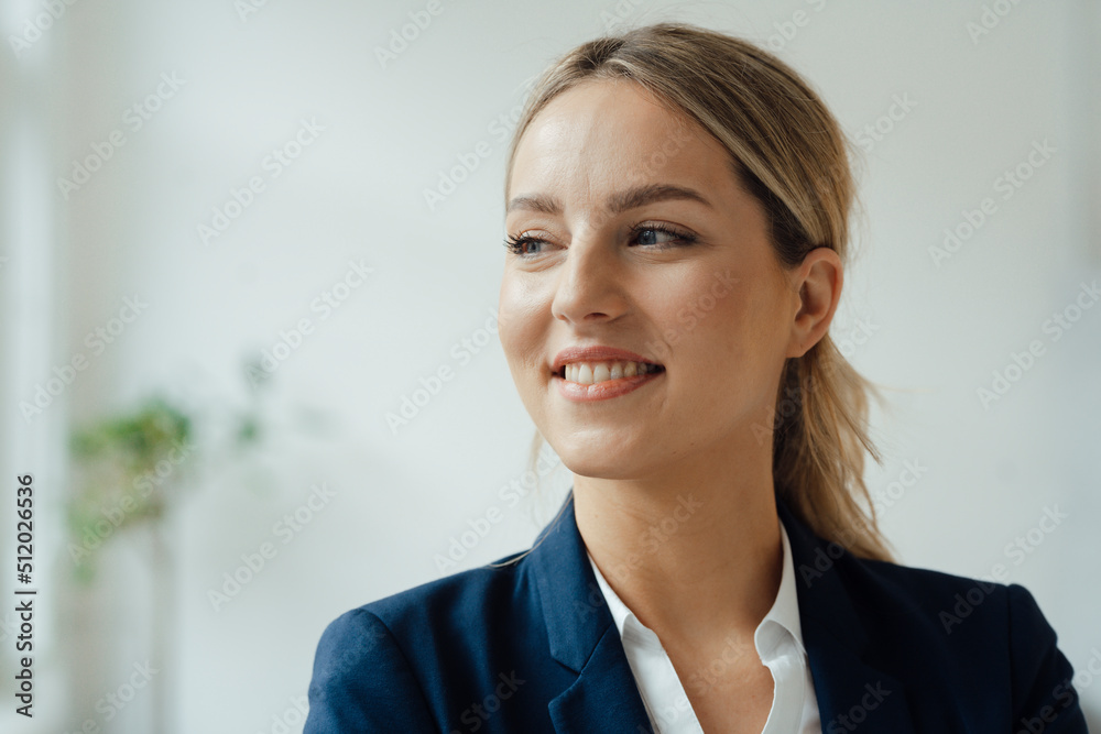 Smiling beautiful businesswoman with blond hair at office Smiling beautiful businesswoman with blond hair at office
