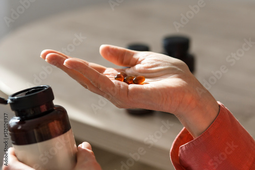 Close-up of woman holding pills photo