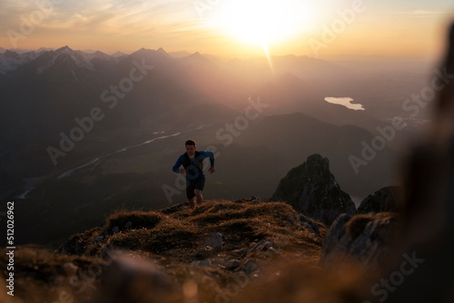 Man hiking on Sauling mountain at sunset photo