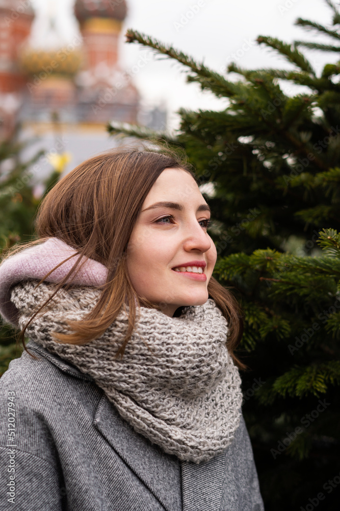 Smiling woman wearing scarf in Christmas market Smiling woman wearing scarf in Christmas market