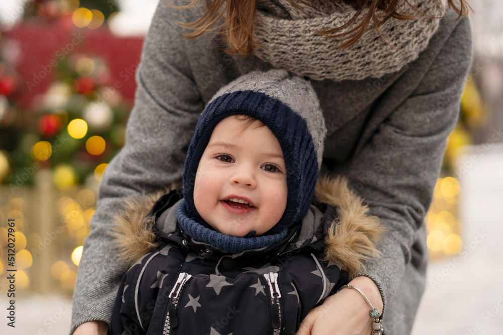 Cute boy with mother at Christmas market Cute boy with mother at Christmas market