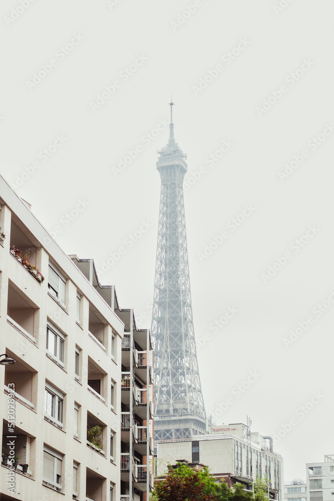 An image of the Eiffel Tower in Paris behind a white building