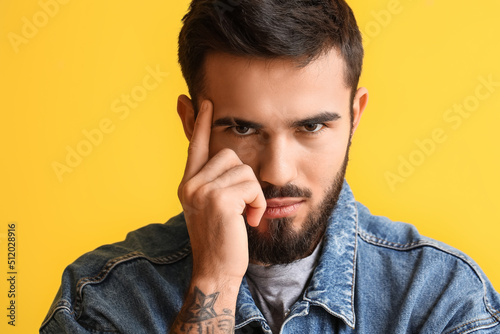 Young bearded man with hand...