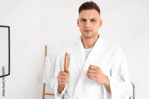 Young man in a white bathro...