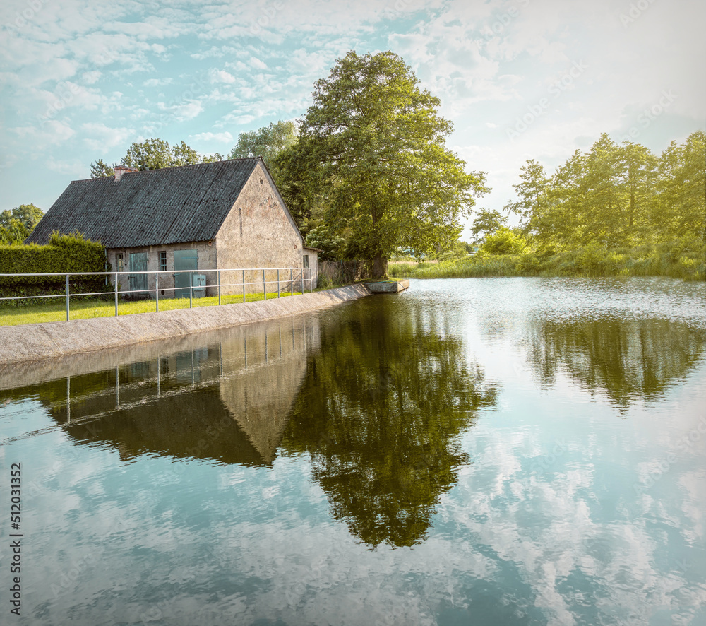 Old house on the bank of the canal. Rural landscape in Holland