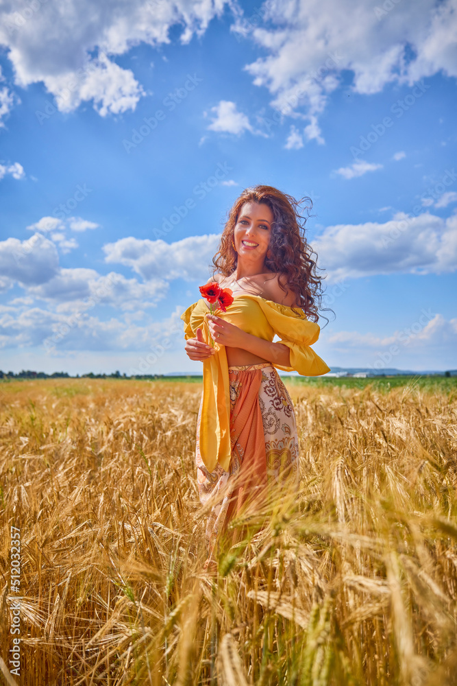 Naklejka premium A happy caucasian young and beautiful woman in a field.
