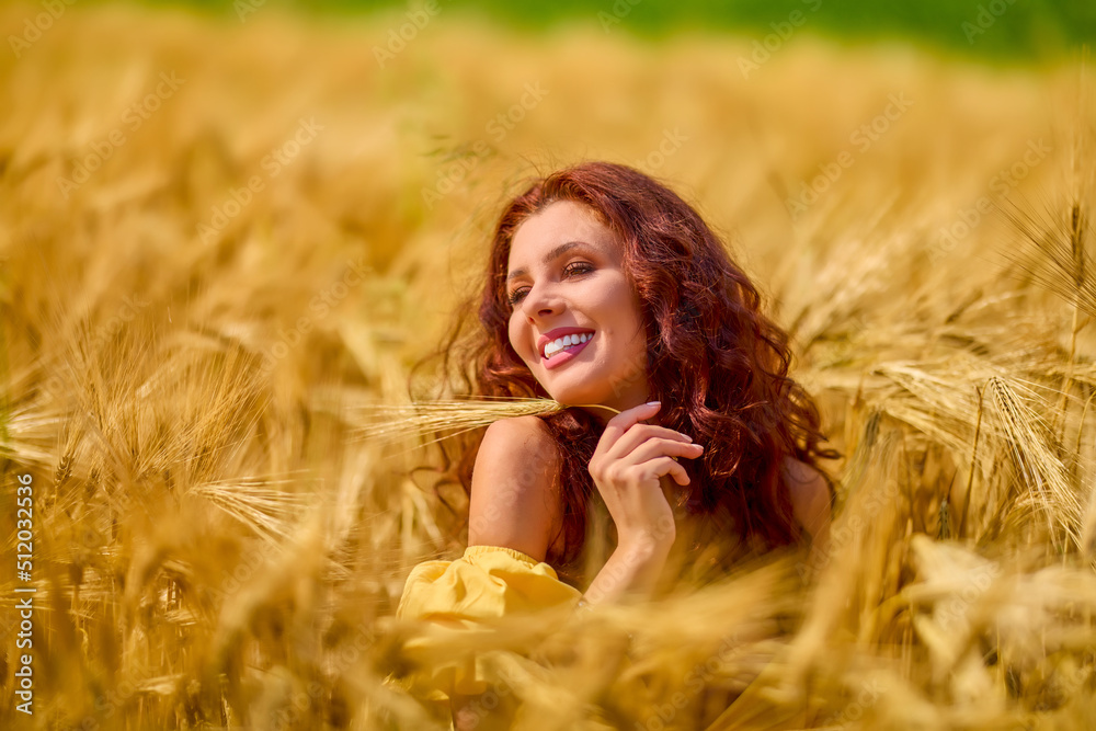 A happy caucasian young and beautiful woman in a field. A happy caucasian young and beautiful woman in a field.
