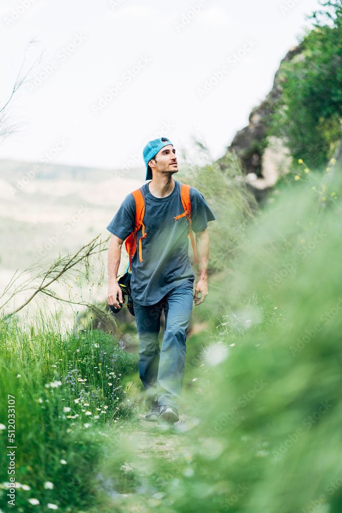 Adventurous man hiking on mountain Adventurous man hiking on mountain